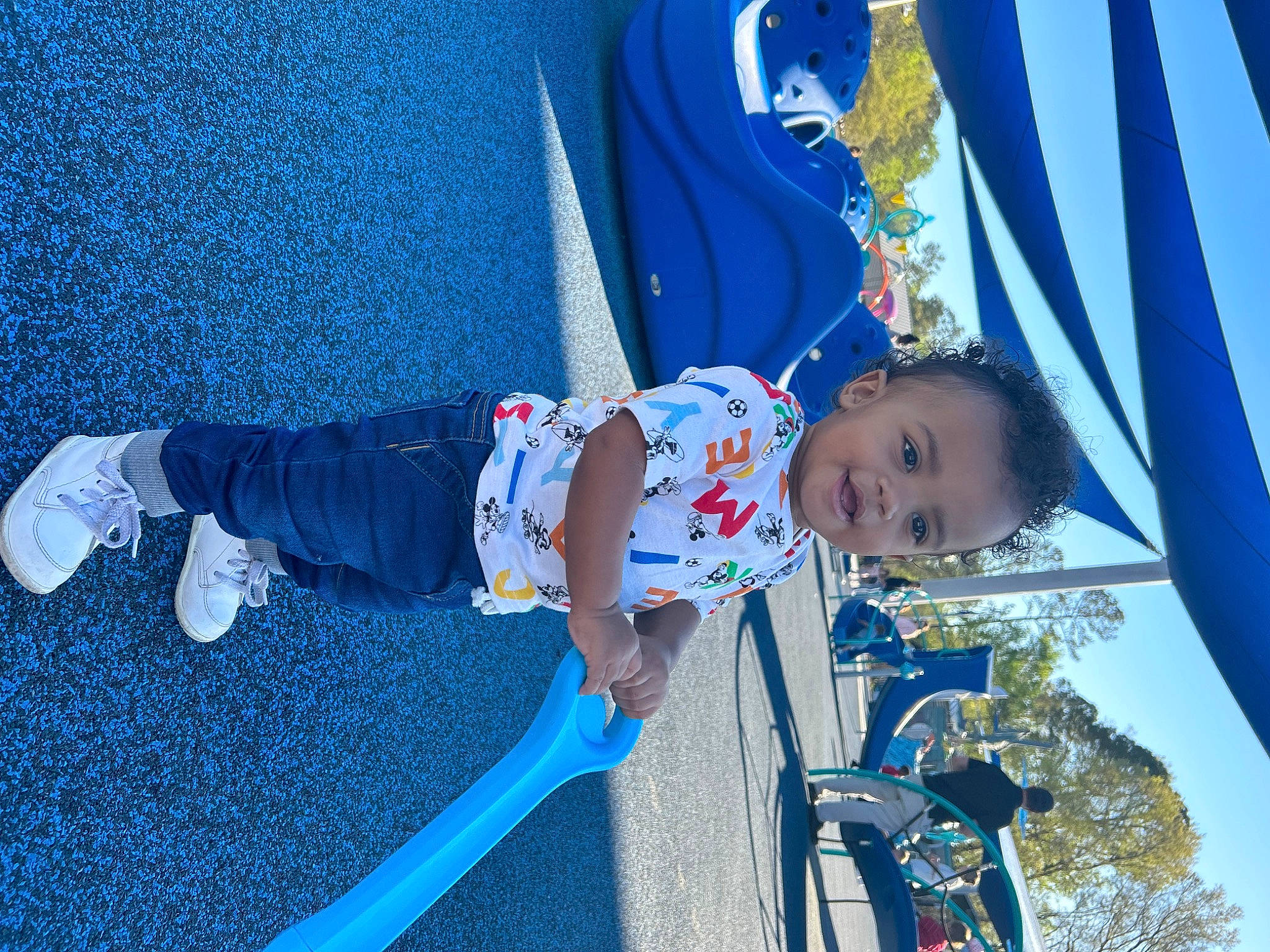 Khynoa is registered to the contest to win money with this photo: azure, baby, blue, child, city, denim, electric_blue, fun, happy, leisure, outdoor_play_equipment, person, playground, recreation, sky, smile, toddler, tree, walking_shoe, wheel