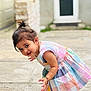 toddler, child, dress, colorful, outdoor, curious, barefoot, bracelet, anklet, smiling, candid, portrait, playful, young_child, person, hair_tied, pavement, door, background_blur, sunlight