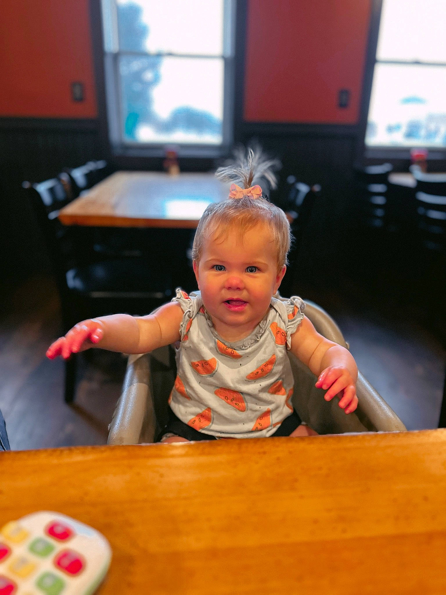 Blakely is registered to the contest to win money with this photo: baby, chair, child, desk, event, finger, flooring, fun, furniture, hardwood, indoor_games_and_sports, leisure, person, recreation, room, sitting, table, toddler, varnish, window