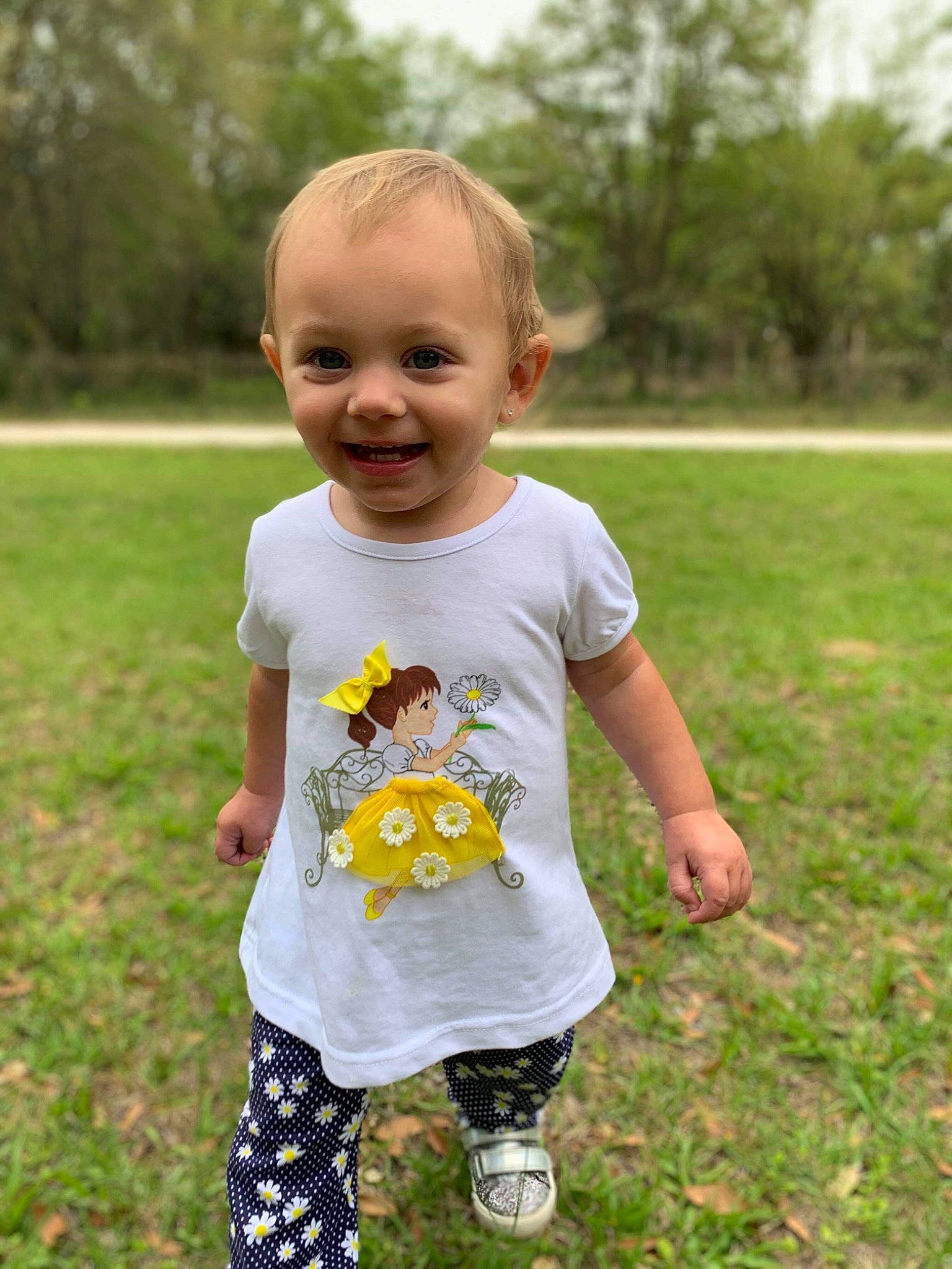 Kyndall joined the competition — help win amazing prizes! baby, baby_toddler_clothing, child, dress, grass, happy, joy, meadow, pattern, person, plant, play, sleeve, smile, spring, summer, t_shirt, toddler, vacation, wildflower