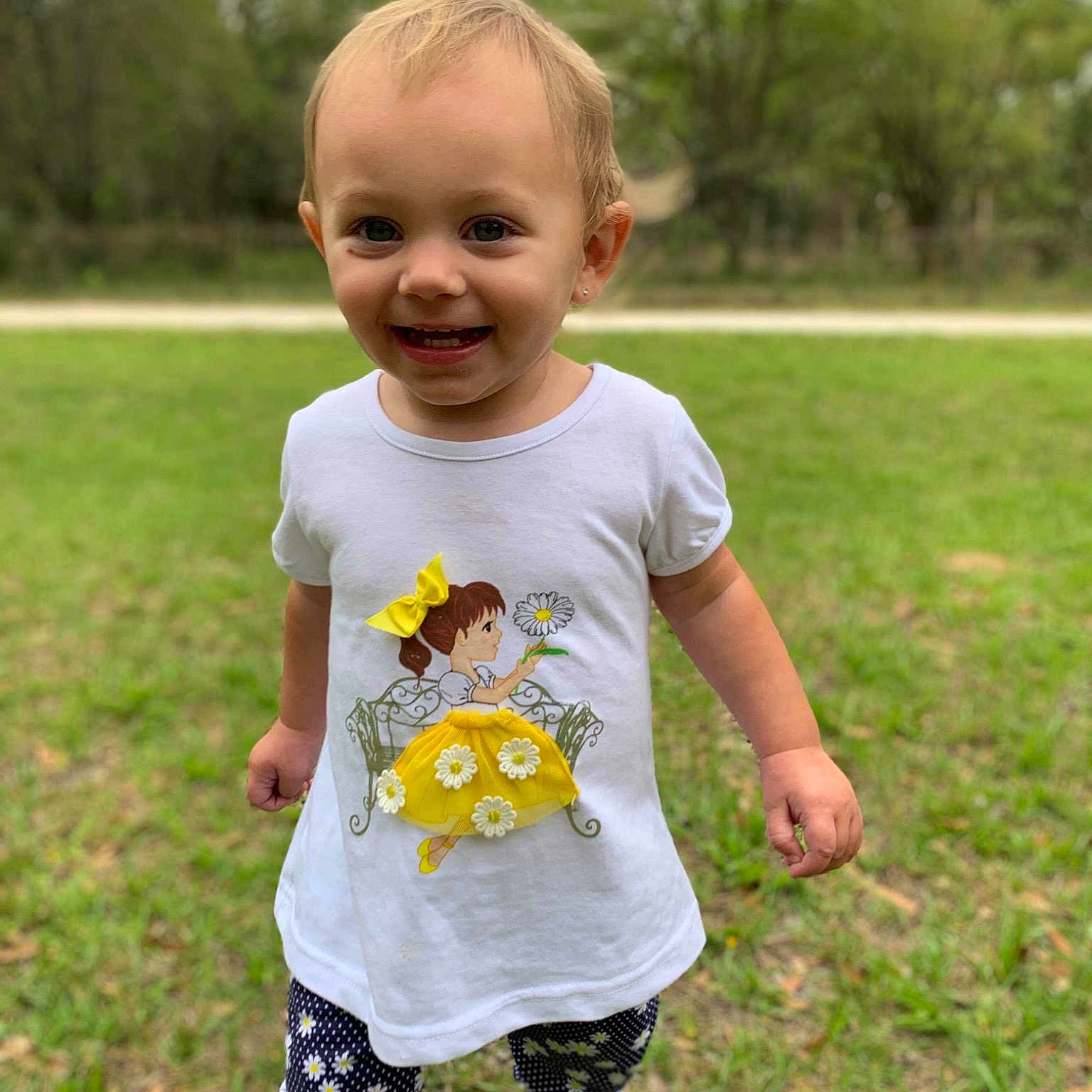 Kyndall joined the competition — help win amazing prizes! baby, baby_toddler_clothing, child, dress, grass, happy, joy, meadow, pattern, person, plant, play, sleeve, smile, spring, summer, t_shirt, toddler, vacation, wildflower