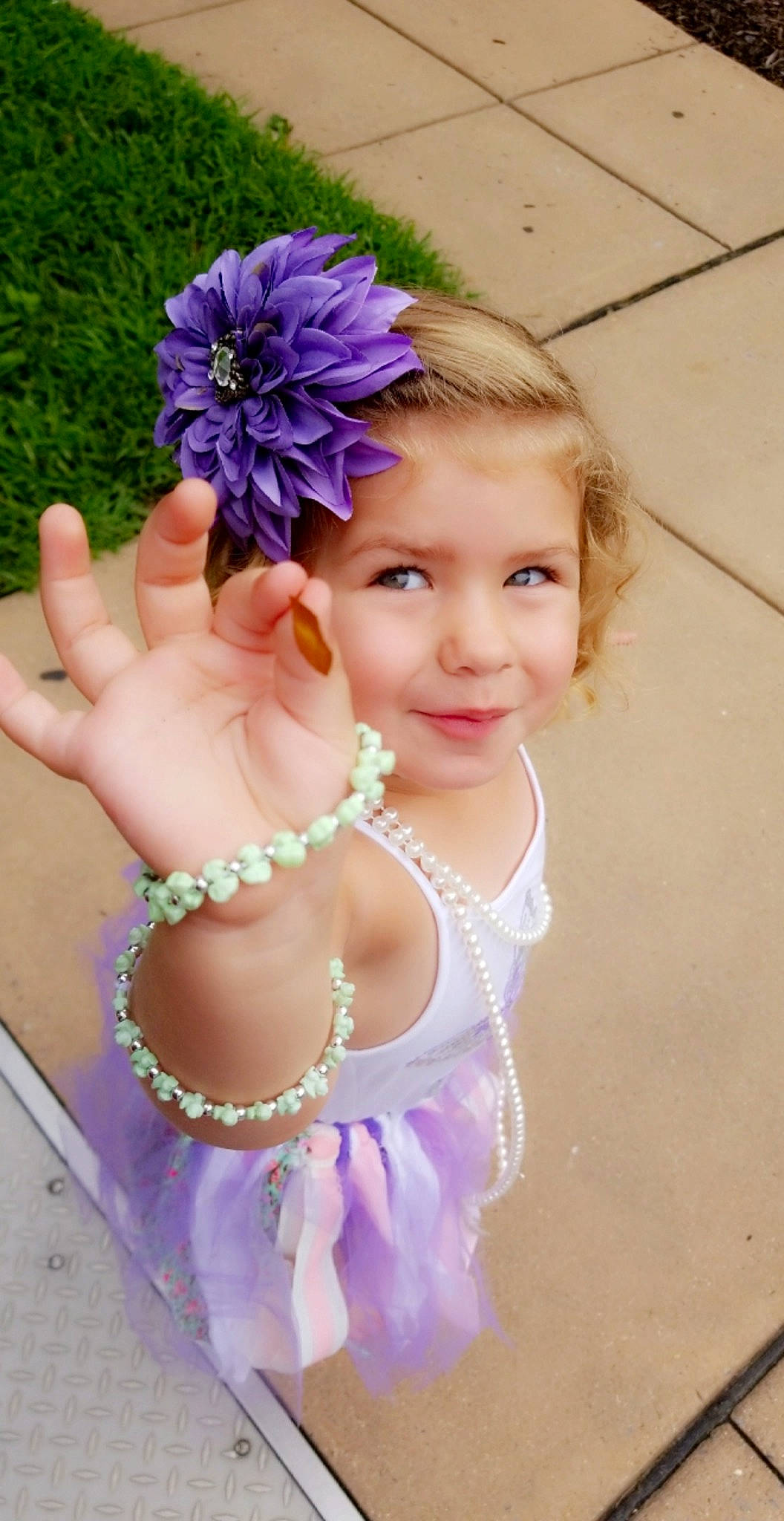 Teigan is registered to the contest to win money with this photo: child, flower, fun, girl, hair_accessory, headpiece, infant, lavender, lilac, person, petal, pink, purple, smile, toddler