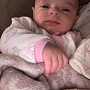 Emily joined the competition — help win amazing prizes! baby, blanket, couch, infant, person, sleepy, hand, soft, cozy, pink, clothing, face, portrait, indoors, cute, young_child, resting, comfort, warm, relaxed