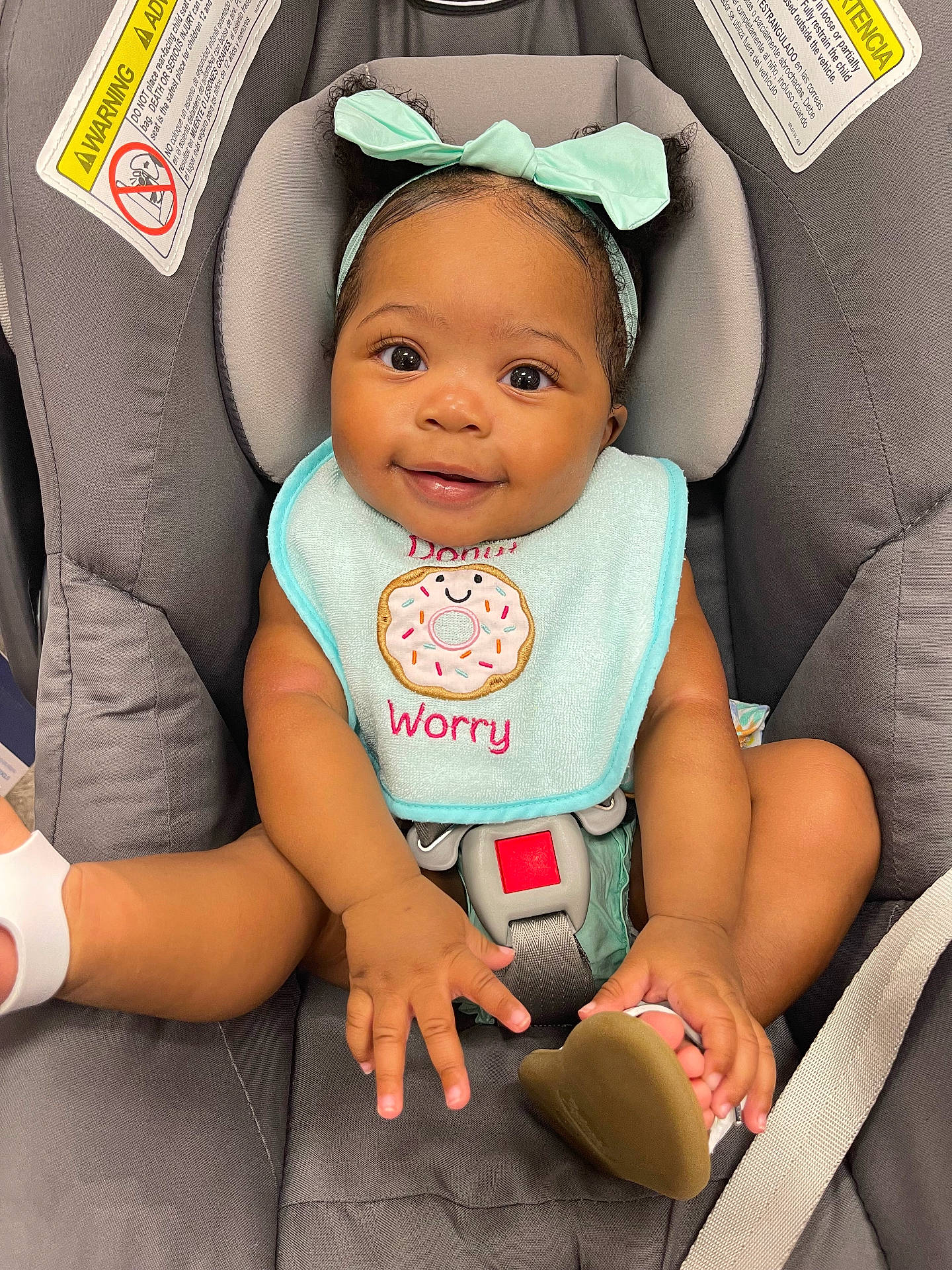 Amani is registered to the contest to win money with this photo: baby, babylaughing, car, car_interior, carseat, clothing, cushion, face, happy, hat, head, headrest, homedecor, person, photography, portrait, sitting, smile, transportation, vehicle