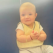Erik joined the competition — help win amazing prizes! baby, background, bracelet, child, clapping, cute, expression, face, hands, happy, indoors, knitwear, portrait, sitting, skin, smiling, soft_light, vest, white_shirt, young_child
