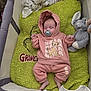 Astrid joined the competition — help win amazing prizes! baby, blanket, cartoon, child, clothing, comfort, cute, green, grinch, hoodie, indoors, infant, lion_cub, pacifier, pants, playpen, plush_toy, rest, sleeping, soft_toy