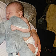 Astrid joined the competition — help win amazing prizes! arm, baby, child, close_up, comfort, cuddle, cushion, diaper, elephant, furniture, hand, indoor, infant, person, relaxation, rest, sleeping, soft_toy, stuffed_animal, tenderness