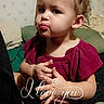affection, baby, casual, child, cozy, curly_hair, cute, expression, face, hands, indoor, love, person, pillow, portrait, red_dress, sitting, text_overlay, toddler, wallpaper
