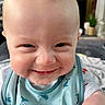 Leo is registered to the contest to win money with this photo: arm, baby, background, bib, child, clothing, cute, dolphin_pattern, expression, face, happy, head, homedecor, indoor, infant, person, room, sitting, skin, smile