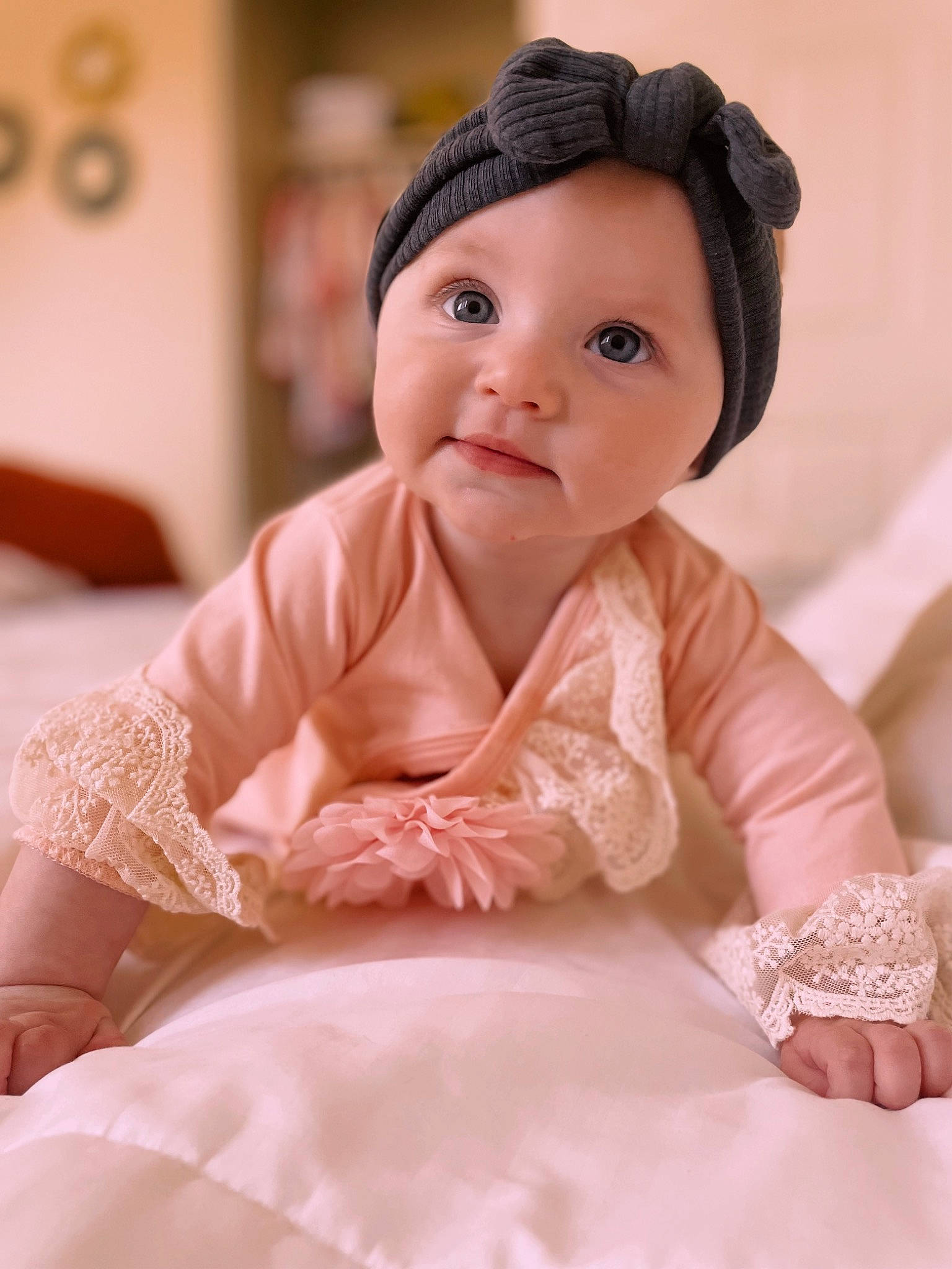 Adrienne is registered to the contest to win money with this photo: baby, baby_toddler_clothing, cap, cheek, child, clothing, embellishment, fashion_accessory, happy, headgear, headwear, lip, outerwear, peach, person, pink, sitting, skin, sleeve, smile
