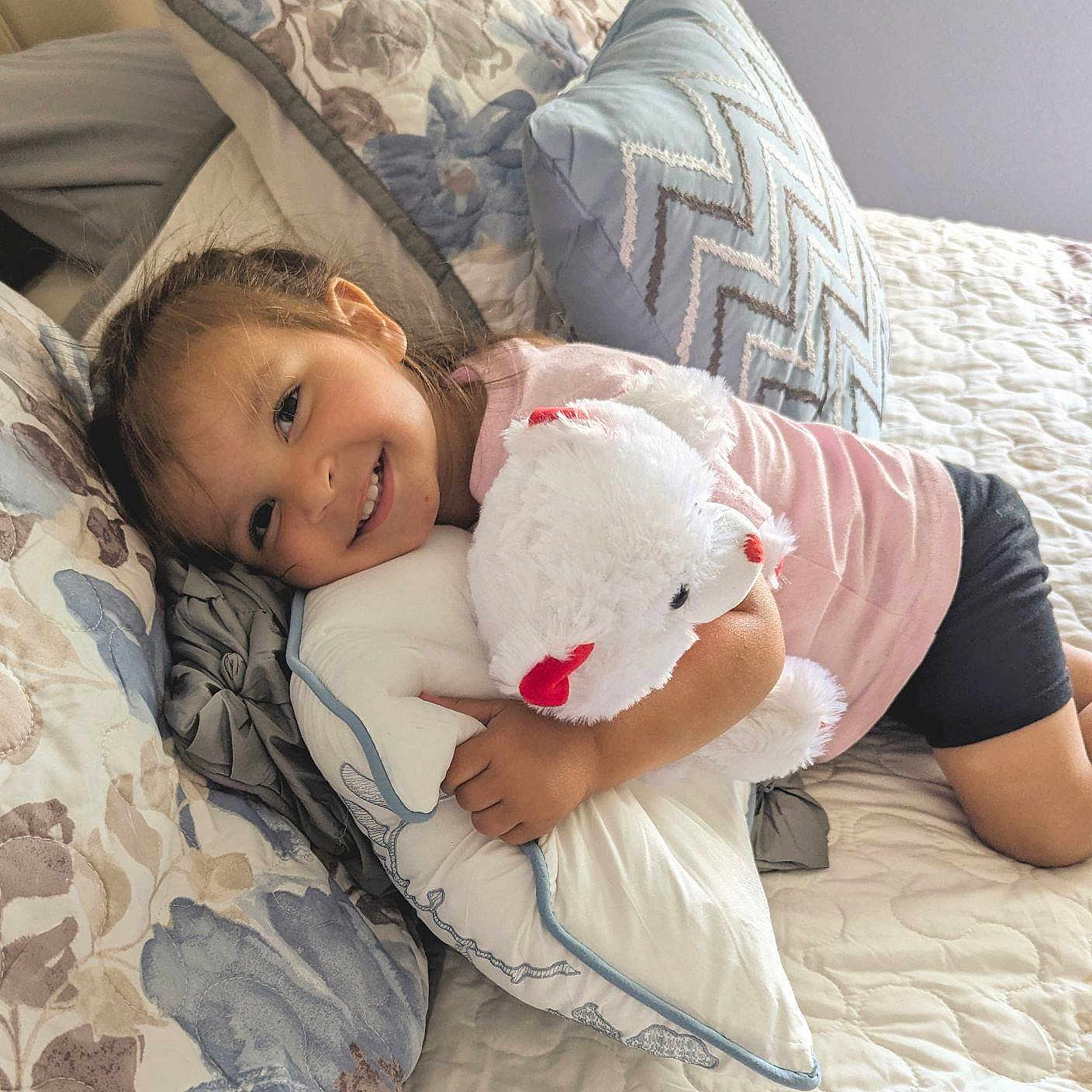Mila is registered to the contest to win money with this photo: baby, ball, bed, bedroom, blanket, couch, cushion, face, football, furniture, head, homedecor, indoors, person, photography, pillow, portrait, room, soccer, soccerball