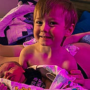 Asher joined the competition — help win amazing prizes! child, baby, newborn, blanket, smile, portrait, indoors, bed, pillow, home, person, cute, happy, family, toddler, holding, colorful, fabric, young, cozy