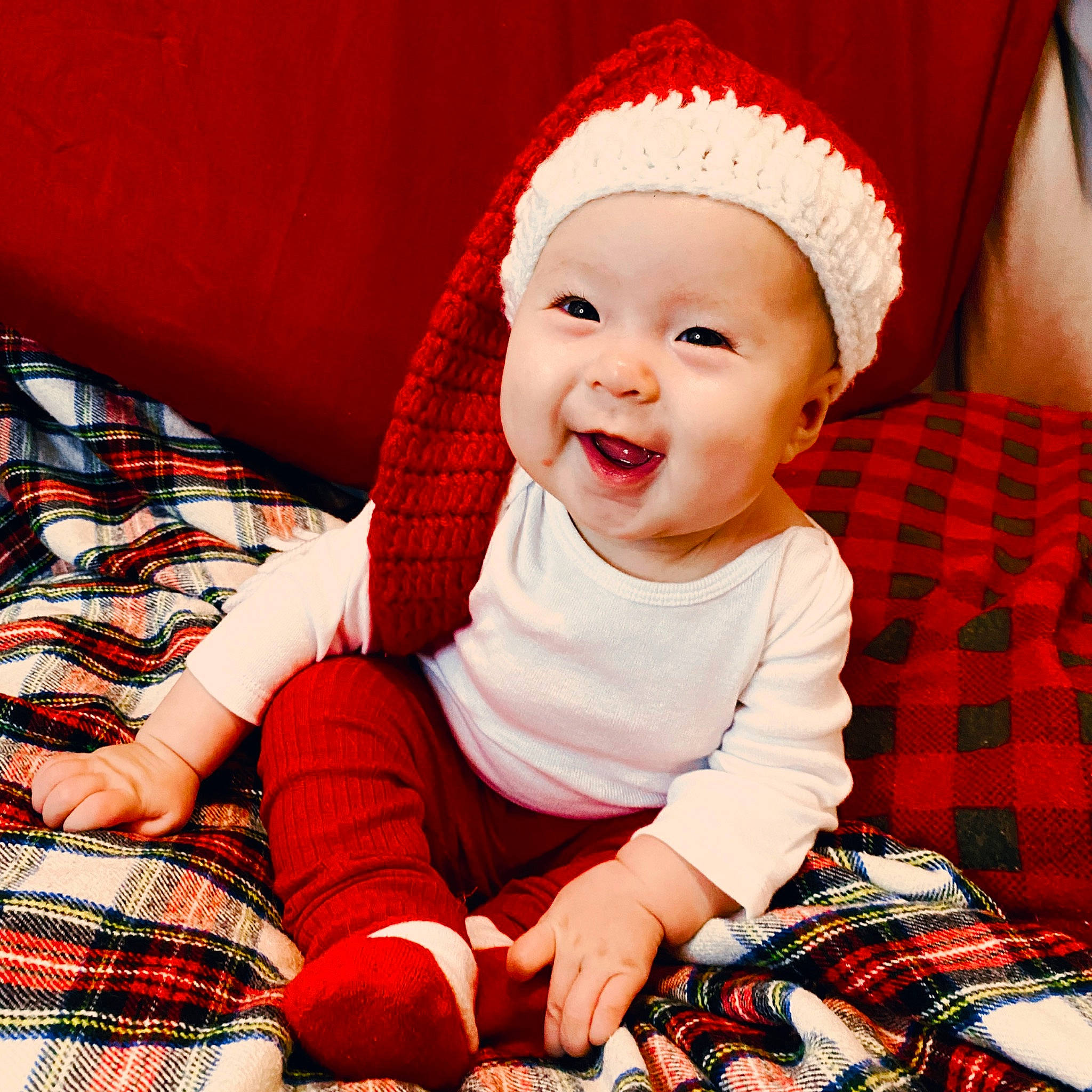 Juniper joined the competition — help win amazing prizes! baby, baby_toddler_clothing, cap, comfort, happy, hat, headwear, human_body, lap, pattern, person, photograph, plaid, red, skin, sleeve, smile, sock, tartan, textile