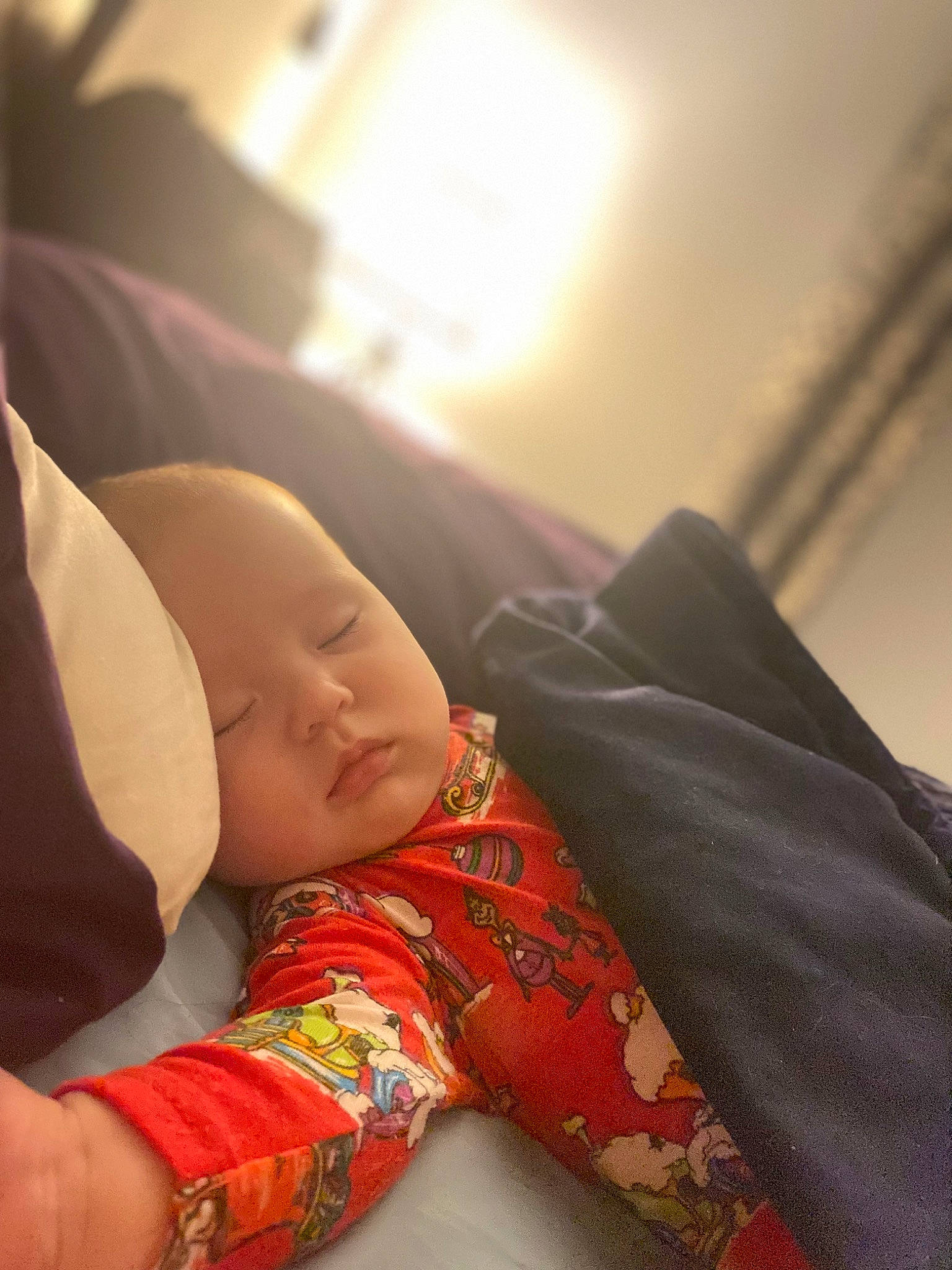 Juniper is registered to the contest to win money with this photo: abdomen, baby, baby_toddler_clothing, bedtime, child, comfort, elbow, flooring, headwear, human_leg, linens, nap, pattern, person, portrait_photography, sitting, sleep, sleeve, thigh, toddler