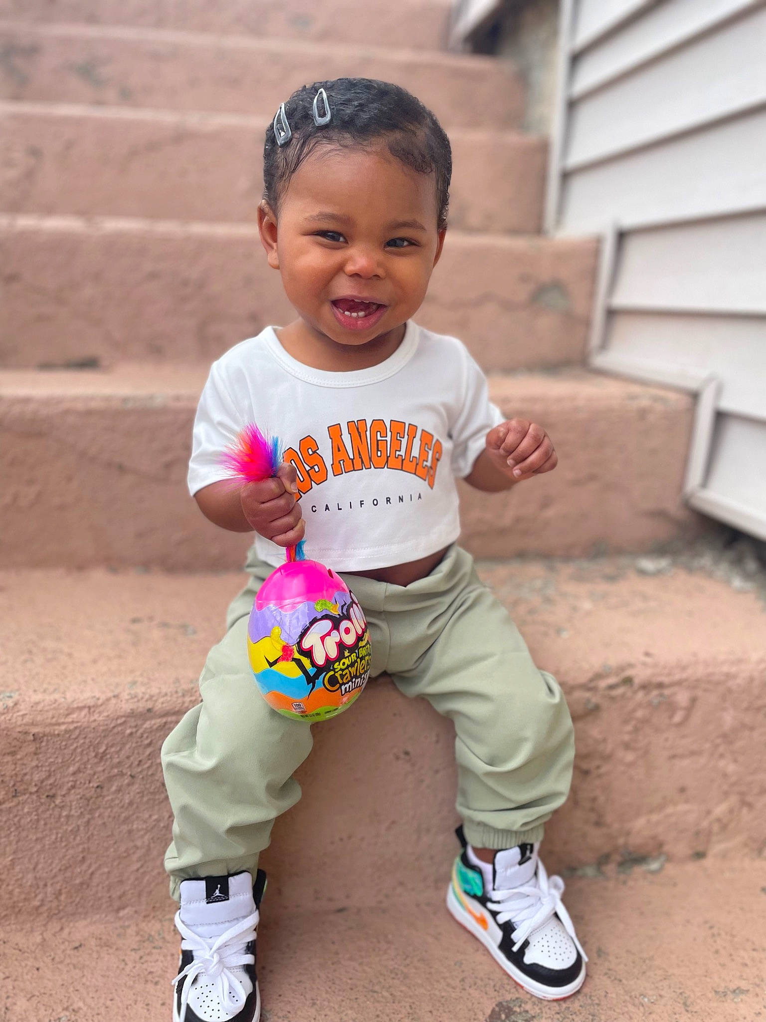 Ohana is registered to the contest to win money with this photo: baby, baby_toddler_clothing, ball, child, cool, face, fun, grass, happy, head, person, pink, skin, sleeve, smile, sneakers, sock, sports_equipment, t_shirt, toddler