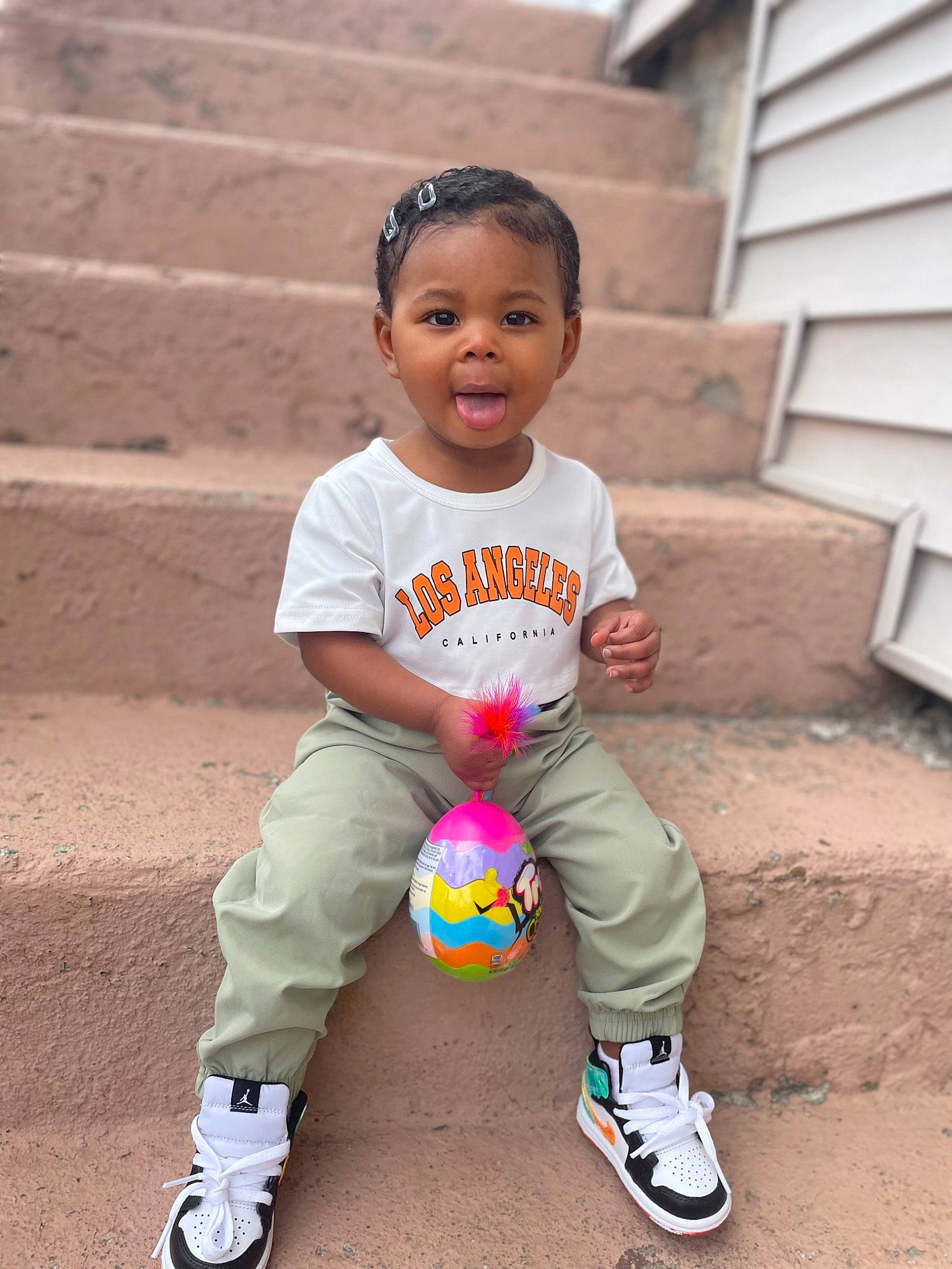 Ohana is registered to the contest to win money with this photo: baby_toddler_clothing, ball, child, face, fun, grass, happy, knee, leisure, people_in_nature, person, shoe, sitting, smile, sneakers, soil, sports_equipment, standing, t_shirt, toddler