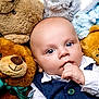 Robert is registered to the contest to win money with this photo: baby, teddy_bear, plush_toy, blue_eyes, white_shirt, vest, infant, cute, soft_toys, child, portrait, indoor, closeup, cuddly, childhood, smiling_toy, hand, face, expression, lying_down