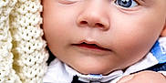 Robert is registered to the contest to win money with this photo: baby, close_up, face, heterochromia, blue_eyes, brown_eyes, knit_blanket, hand, skin, infant, portrait, cute, child, soft_texture, warmth, clothing, newborn, expression, innocence, curiosity