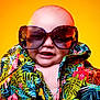 baby, child, sunglasses, tropical_shirt, colorful_clothing, smile, portrait, closeup, head, face, happy, fashion, summer, yellow_background, cute, fun, toddler, eyewear, bright, vibrant