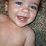 baby, child, smiling, blue_eyes, happy, curly_hair, bare_chest, carpet, person, portrait, cute, infant, human, skin, tongue, teeth, hand, lying_down, playful, closeup