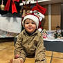 candid, celebration, child, christmas, clothing, cute, decorations, festive, floor, happy, holiday, indoors, portrait, santa_hat, seasonal, smile, stockings, tile, toddler, tree