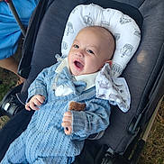 Max joined the competition — help win amazing prizes! baby, smiling, stroller, blue_knit_outfit, pillow, toy, hand, face, outdoor, grass, footwear, white_shoe, fabric, head_support, happy, infant, child, person, cute, cozy