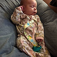 Leia joined the competition — help win amazing prizes! baby, child, clothing, comfort, cozy, cute, face, floral_pattern, hand, indoors, infant, newborn, onesie, pacifier, peaceful, portrait, relaxing, skin, sleeping, soft_cushion