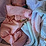 newborn, baby, sleeping, pacifier, pink_outfit, blanket, soft, cozy, infant, cute, peaceful, resting, child, bed, fabric, portrait, sleepwear, wrapped, tiny, hands