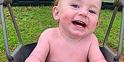 Wesley is registered to the contest to win money with this photo: baby, child, daytime, face, fun, grass, hand, happy, nature, outdoor, park, person, play, playground, seat, skin, smiling, swing, toddler, toy