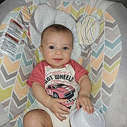 Dominick Bloom joined the competition — help win amazing prizes! baby, infant, child, smiling, hot_wheels, car_print, onesie, baby_seat, patterned_cushion, toy, bowl_lid, indoor, cute, headrest, ears, comfort, colorful, happy, portrait, childcare