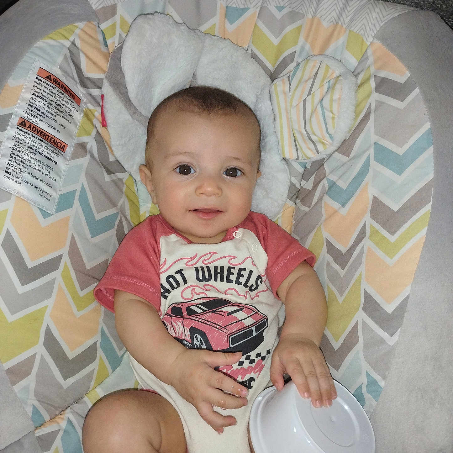 Dominick Bloom joined the competition — help win amazing prizes! baby, infant, child, smiling, hot_wheels, car_print, onesie, baby_seat, patterned_cushion, toy, bowl_lid, indoor, cute, headrest, ears, comfort, colorful, happy, portrait, childcare