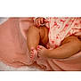 baby, blanket, child, close_up, clothing, cute, fabric, feet, infant, legs, nail_polish, pattern, pearls, pink, resting, skin, soft_texture, toddler, toenails, warm_colors
