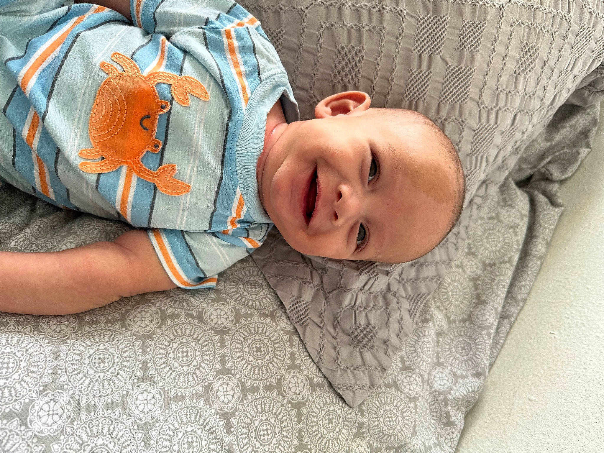 Eziah joined the competition — help win amazing prizes! baby, baby_products, baby_toddler_clothing, child, comfort, eye, flooring, fun, grass, happy, joy, linens, pattern, person, room, sitting, skin, sleeve, smile, toddler