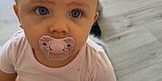Lorena participe au concours pour gagner de l'argent avec cette photo : baby, infant, pacifier, blue_eyes, sitting, floor, wooden_floor, pink_clothing, child, cute, indoors, looking, skin, short_hair, human, portrait, young, hand, foot, natural_light