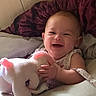 Eloise is registered to the contest to win money with this photo: baby, infant, child, smiling, laughing, portrait, stuffed_animal, bunny, toy, cuddling, bed, bedding, pillow, blanket, indoor, cozy, sitting, happy, face, home