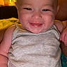 Eloise joined the competition — help win amazing prizes! baby, infant, child, smiling, happy, portrait, face, close_up, indoors, bedroom, warm_lighting, striped_onesie, sleeveless_clothing, sitting, couch, blanket, lamp, bottle, cozy, photography