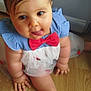 Zheïna a rejoint le concours — aidez-le/la à gagner de superbes lots ! baby, child, pigtails, tongue_out, dress, red_bow, blue_clothing, cute, chubby, indoors, wooden_floor, smiling, person, happy, sitting, portrait, young_child, playful, hand, foot