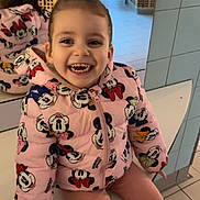 Syana participe au concours pour gagner de l'argent avec cette photo : child, girl, toddler, smile, jacket, minnie_mouse, pink, sitting, bench, mirror, reflection, teeth, sneakers, tiles, tiled_floor, hallway, doorway, happy, indoor, portrait