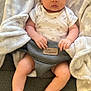 Adriana joined the competition — help win amazing prizes! baby, infant, onesie, blanket, baby_seat, cushion, face, person, barefoot, hand, foot, wooden_floor, fabric, soft_texture, indoor, cute, child, comfort, sitting, expression