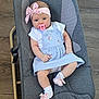 baby, infant, pacifier, headband, bow, dress, blue_dress, socks, pink_socks, baby_rocker, gray_rocker, wooden_floor, cute, child, person, indoor, comfort, clothing, portrait, relaxing