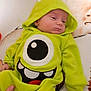Anthony joined the competition — help win amazing prizes! animal_print, baby, bed, cartoon_face, child, clothing, cute, green_onesie, hand, hooded_clothing, indoors, infant, monster_costume, person, plush, resting, sleeping, sleepy, soft, toddler