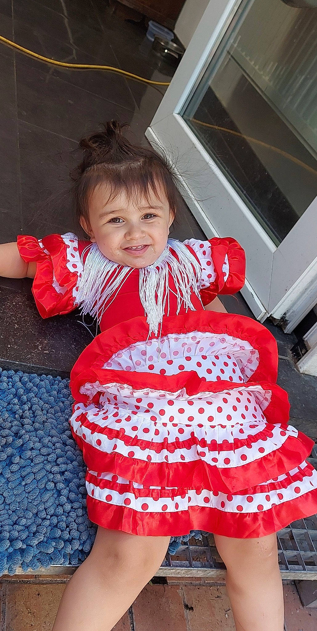 Gina participe au concours pour gagner de l'argent avec cette photo : baby_toddler_clothing, day_dress, dress, event, facial_expression, fashion_accessory, fun, happy, holiday, human_leg, joy, pattern, person, pink, red, ruffle, sleeve, smile, thigh, toddler