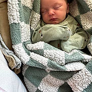 Norajean joined the competition — help win amazing prizes! baby, newborn, sleeping, blanket, green, white, cozy, onesie, infant, cute, soft, checkered, wrapped, resting, peaceful, portrait, child, indoors, cushion, warm