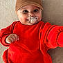 baby, child, pacifier, cap, brown_cap, red_sweater, smiling, cute, infant, portrait, hand, face, indoors, clothing, happy, young_child, sitting, looking_at_camera, skin, person