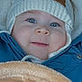 baby, blanket, blue_jacket, bundled_up, cheeks, child, closeup, cozy, eyes, fabric, fur_lining, hood, infant, knitted_hat, long_eyelashes, portrait, smile, stroller, warmth, winter