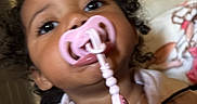 Nova joined the competition — help win amazing prizes! accessory, baby, casual, child, close_up, clothing, curly_hair, cute, expression, face, home, indoor, pacifier, person, pink, portrait, soft_lighting, toddler, wall_art, young_child