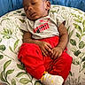 baby, child, clothing, comfort, couch, cushion, grey_shirt, home, indoor, infant, leaf_pattern, nap, peaceful, person, pillow, red_pants, relaxation, skin, sleeping, socks