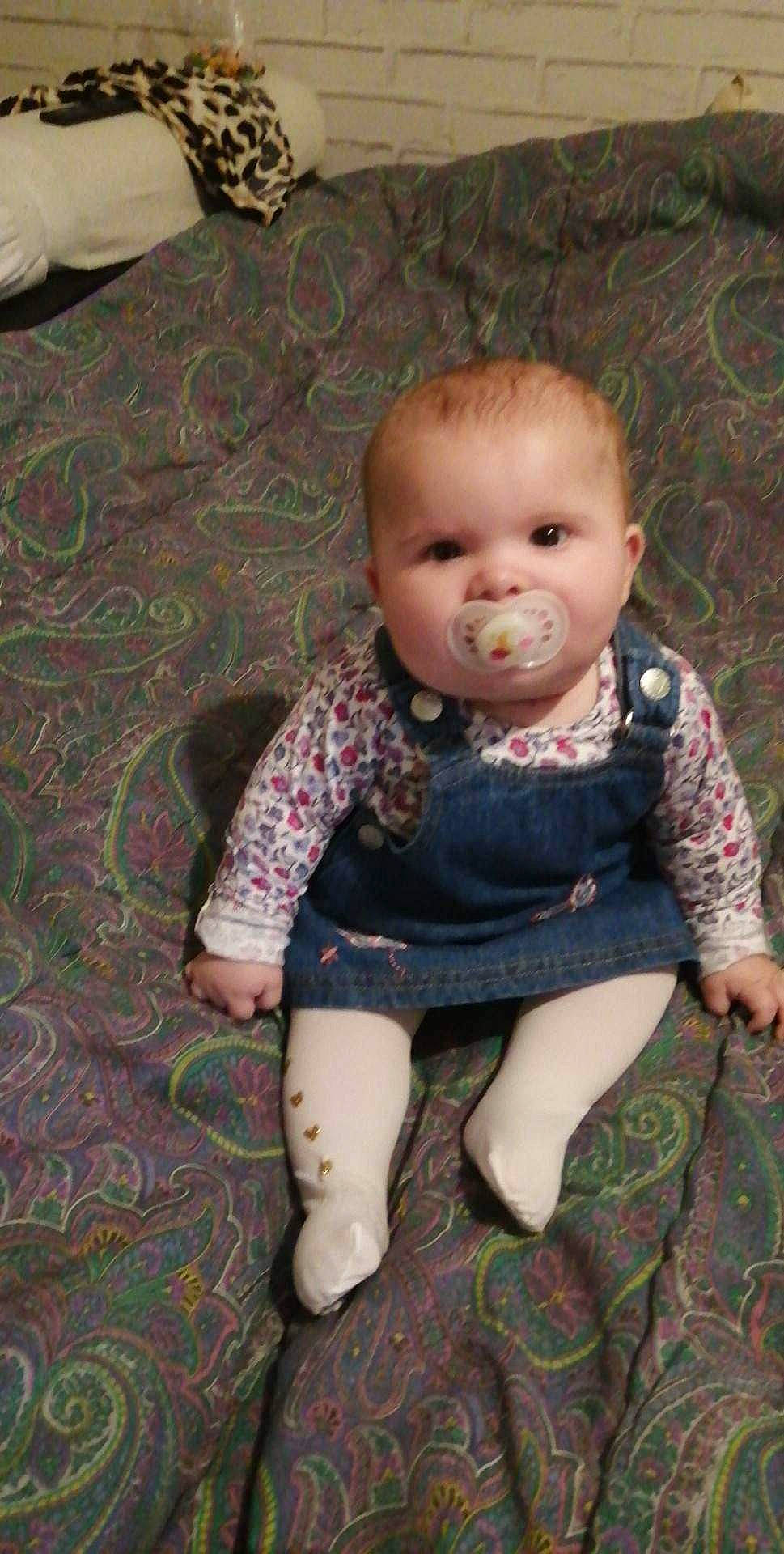 Léa a rejoint le concours — aidez-le/la à gagner de superbes lots ! baby, baby_products, baby_toddler_clothing, chair, cheek, child, comfort, dress, flooring, human_body, iris, joint, lip, pattern, person, sitting, skin, sleeve, sock, toddler