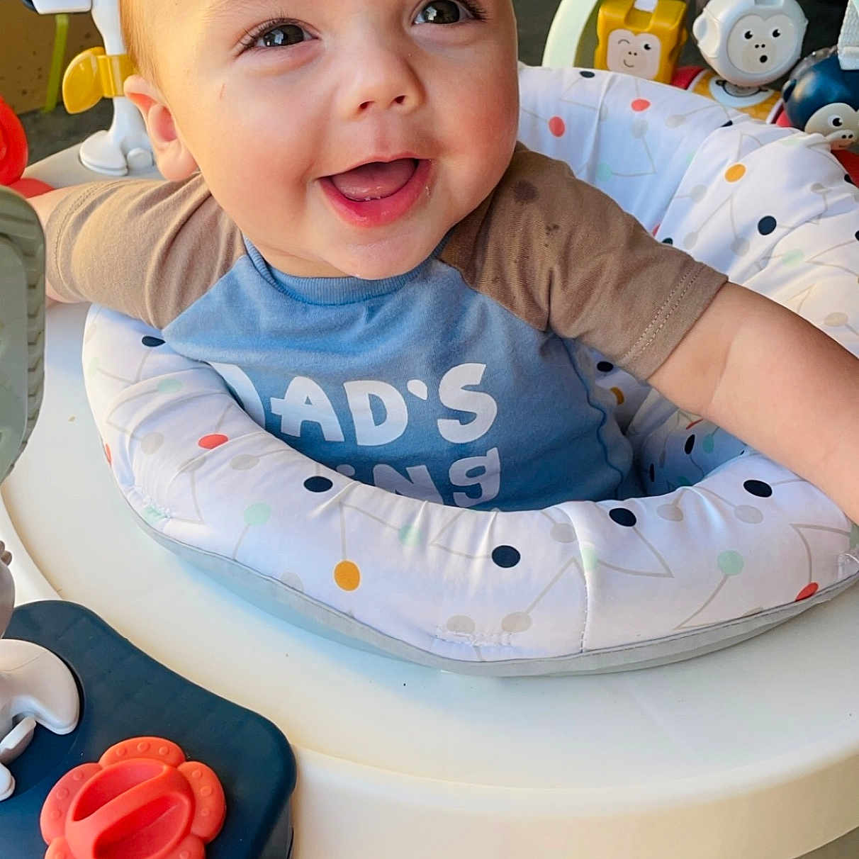 Anderson is registered to the contest to win money with this photo: baby, babylaughing, bodypart, can, clothing, cutlery, face, furniture, happy, head, mouth, person, photography, portrait, sitting, smile, spoon, t_shirt, teeth, tin