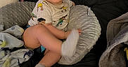 Liam is registered to the contest to win money with this photo: baby, child, infant, portrait, sitting, smiling, face, eyes, indoors, bed, blanket, pillow, cushion, clothing, shirt, socks, toy, cozy, home, photography